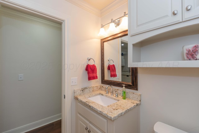 7901 Kingsgate Dr, Amarillo, TX 79119 - half bath featuring vanity, ornamental molding, and wood finished floors