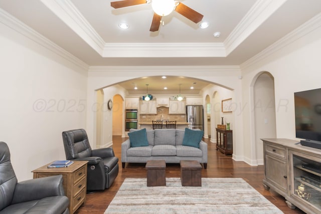 7901 Kingsgate Dr, Amarillo, TX 79119 - living room with arched walkways, a tray ceiling, ceiling fan, and ornamental molding