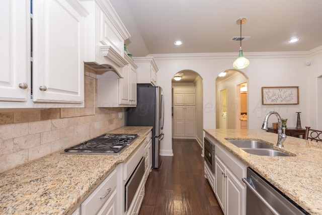 7901 Kingsgate Dr, Amarillo, TX 79119 - kitchen featuring stainless steel appliances, arched walkways, white cabinets, dark wood-type flooring, and decorative light fixtures