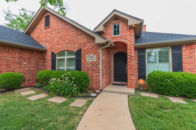 7901 Kingsgate Dr, Amarillo, TX 79119 - view of front facade with brick siding, a shingled roof, and a front lawn
