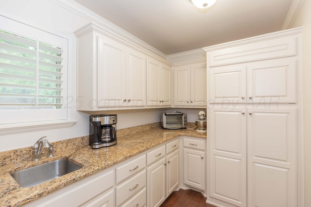 7901 Kingsgate Dr, Amarillo, TX 79119 - kitchen with white cabinets, light stone countertops, and dark wood-style floors