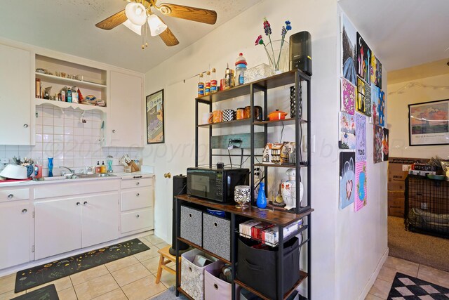 4621 Crockett St, Amarillo, TX 79110 - kitchen with black microwave, open shelves, a ceiling fan, light tile patterned floors, and light countertops