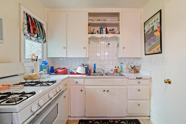 4621 Crockett St, Amarillo, TX 79110 - kitchen featuring white gas range, light countertops, tasteful backsplash, and open shelves