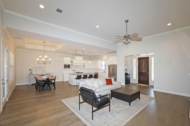 6107 Bowery, Amarillo, TX 79119 - living room featuring ornamental molding, wood finished floors, baseboards, a chandelier, and a ceiling fan