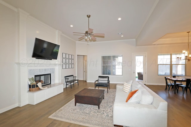 6107 Bowery, Amarillo, TX 79119 - living room with a chandelier, wood finished floors, crown molding, a fireplace, and baseboards