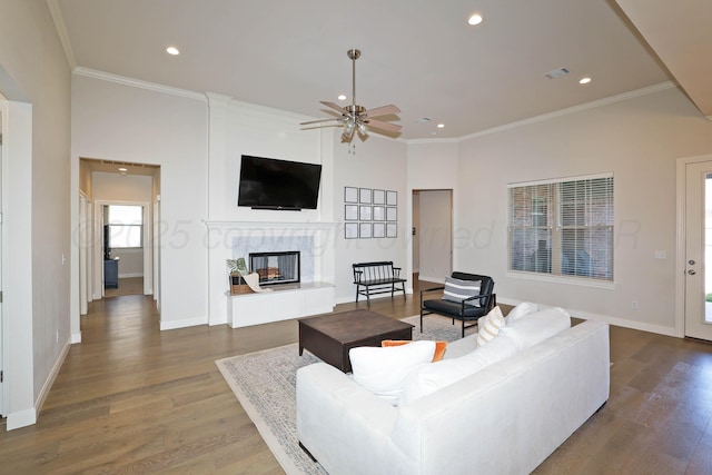 6107 Bowery, Amarillo, TX 79119 - living area with ceiling fan, wood finished floors, a tile fireplace, ornamental molding, and recessed lighting