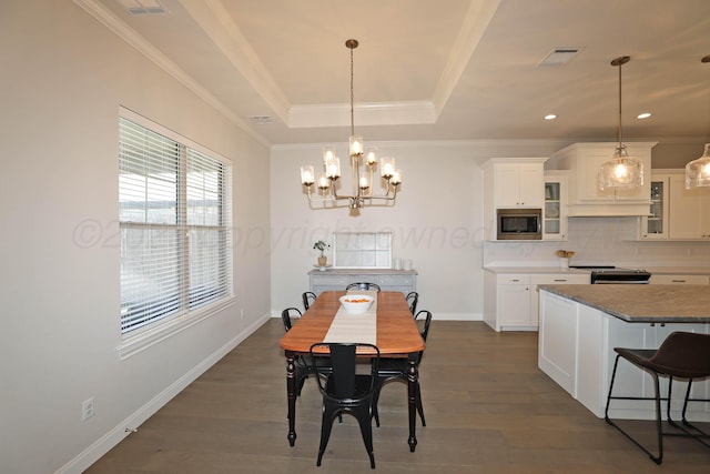 6107 Bowery, Amarillo, TX 79119 - dining area featuring a chandelier, dark wood finished floors, ornamental molding, baseboards, and a raised ceiling