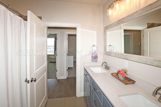 6107 Bowery, Amarillo, TX 79119 - bathroom with wood finished floors, double vanity, and baseboards