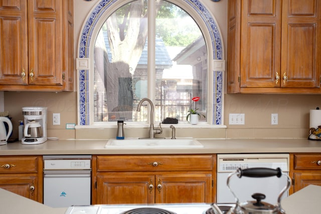 18 Cloister Pkwy, Amarillo, TX 79121 - kitchen featuring dishwasher, light countertops, and brown cabinets