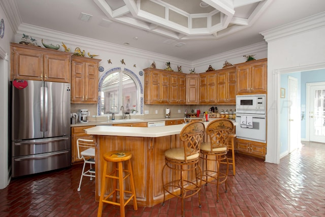 18 Cloister Pkwy, Amarillo, TX 79121 - kitchen with white appliances, healthy amount of natural light, ornamental molding, brick floors, and brown cabinetry