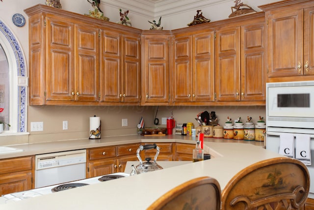 18 Cloister Pkwy, Amarillo, TX 79121 - kitchen with white appliances, light countertops, brown cabinets, and ornamental molding