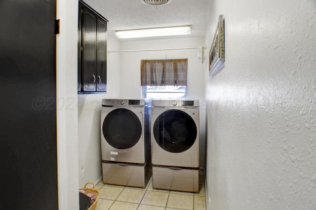 laundry room with washing machine and clothes dryer and light tile patterned floors