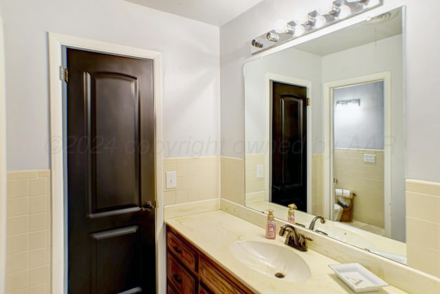 bathroom with tile walls and vanity