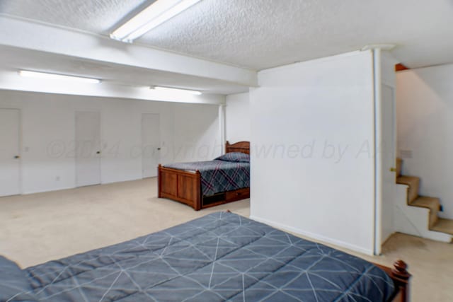 bedroom featuring a textured ceiling and carpet