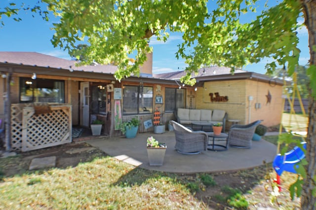 back of property featuring an outdoor living space and a patio area