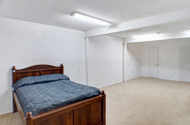 carpeted bedroom with a textured ceiling