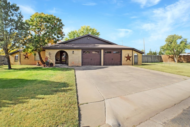 ranch-style house featuring a garage and a front lawn