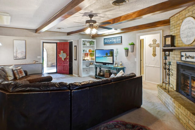 carpeted living room featuring a textured ceiling, a fireplace, ceiling fan, and beam ceiling