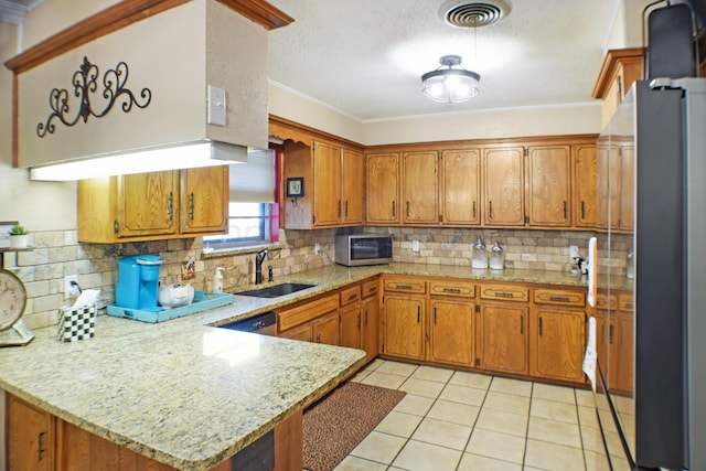 kitchen with kitchen peninsula, sink, crown molding, and stainless steel appliances