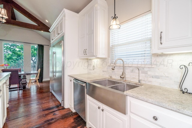 6903 Silverbell Ln, Amarillo, TX 79124 - kitchen featuring stainless steel appliances, a sink, tasteful backsplash, dark wood-style flooring, and white cabinetry