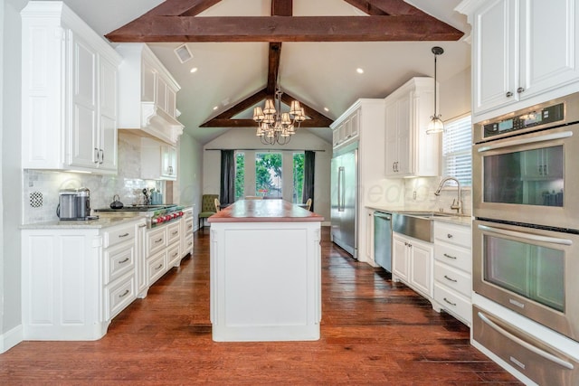6903 Silverbell Ln, Amarillo, TX 79124 - kitchen featuring appliances with stainless steel finishes, a chandelier, a warming drawer, a kitchen island, and white cabinetry