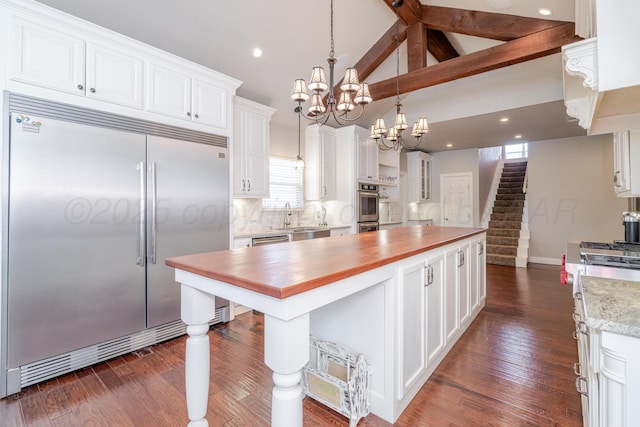 6903 Silverbell Ln, Amarillo, TX 79124 - kitchen featuring stainless steel appliances, white cabinets, a chandelier, a sink, and a kitchen island