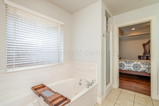 6903 Silverbell Ln, Amarillo, TX 79124 - bathroom featuring connected bathroom, tile patterned floors, a tub with jets, and plenty of natural light