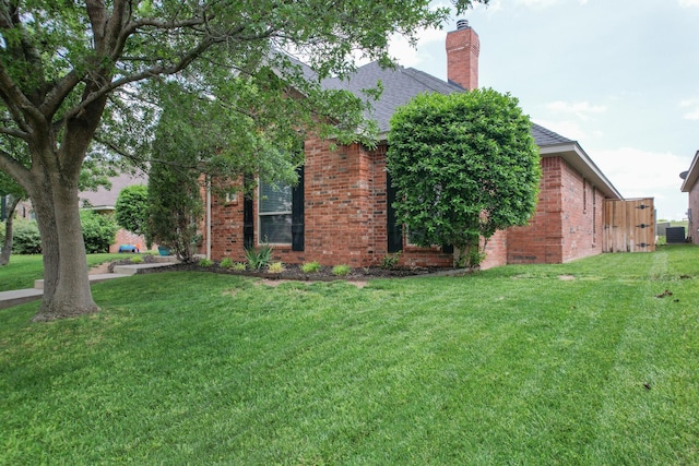 6903 Silverbell Ln, Amarillo, TX 79124 - view of property exterior featuring brick siding, a yard, roof with shingles, and a chimney