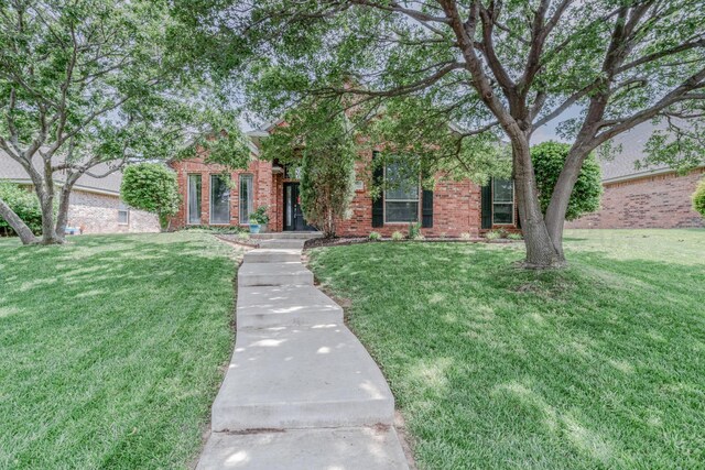 6903 Silverbell Ln, Amarillo, TX 79124 - view of property hidden behind natural elements with brick siding and a front lawn