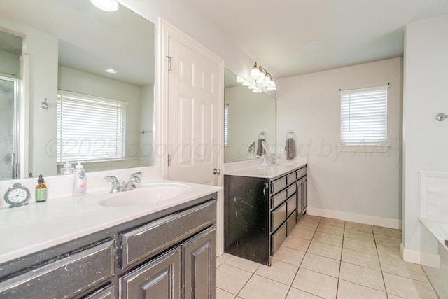 6903 Silverbell Ln, Amarillo, TX 79124 - bathroom featuring two vanities, tile patterned flooring, baseboards, and a bathtub