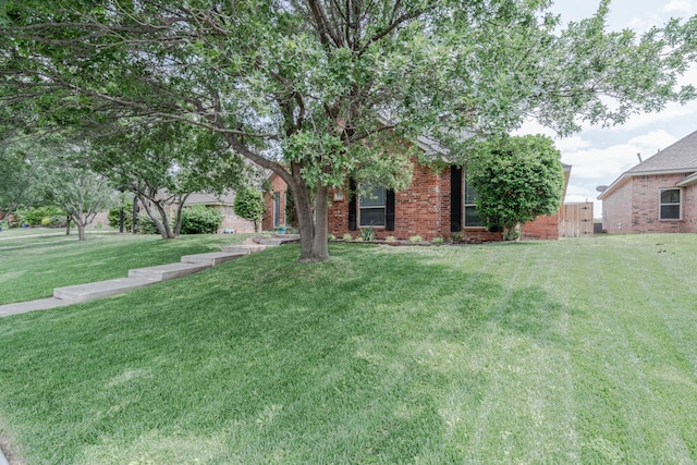 6903 Silverbell Ln, Amarillo, TX 79124 - obstructed view of property featuring a front lawn and brick siding