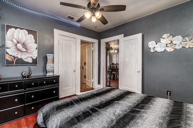 bedroom with dark wood-type flooring and ceiling fan