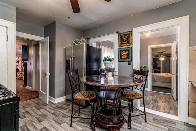 dining space with hardwood / wood-style flooring and ceiling fan