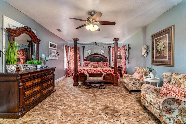 carpeted bedroom featuring a textured ceiling and ceiling fan