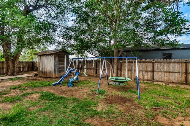 view of jungle gym featuring a storage unit and a yard