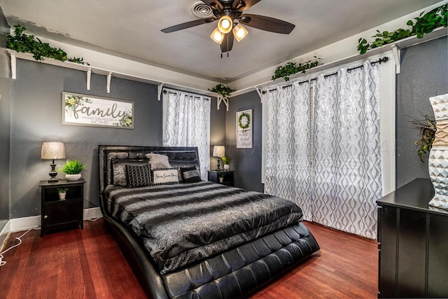 bedroom featuring ceiling fan and dark hardwood / wood-style floors