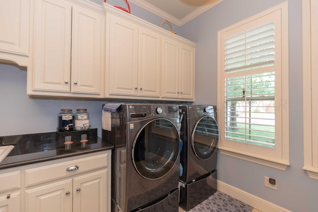 laundry room with ornamental molding, cabinets, and washing machine and clothes dryer