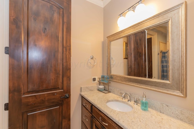 bathroom featuring vanity and ornamental molding