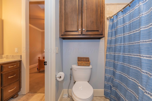 bathroom featuring walk in shower, vanity, tile patterned floors, and toilet