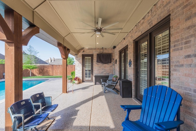 view of patio featuring ceiling fan and a fenced in pool