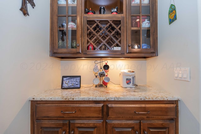 bar featuring light stone countertops