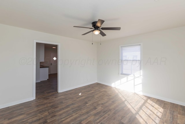 spare room with ceiling fan and dark hardwood / wood-style flooring