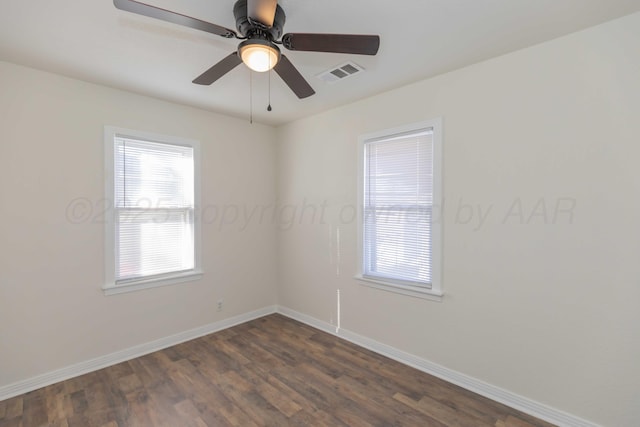 spare room featuring dark hardwood / wood-style flooring and ceiling fan