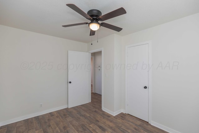 unfurnished bedroom featuring dark hardwood / wood-style floors and ceiling fan