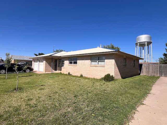 242 Beach St, Hereford, TX 79045 - view of front of house with an attached garage and brick siding