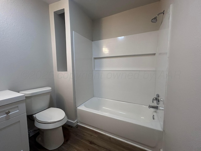 1223 Keeler Ave, Dalhart, TX 79022 - full bathroom with vanity, wood finished floors, bathing tub / shower combination, and toilet