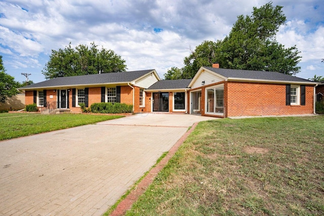 1802 Chama St, Amarillo, TX 79102 - ranch-style house with decorative driveway, brick siding, a front lawn, and a chimney