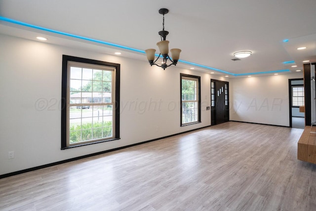 1802 Chama St, Amarillo, TX 79102 - unfurnished room featuring recessed lighting, plenty of natural light, light wood-style floors, and a chandelier