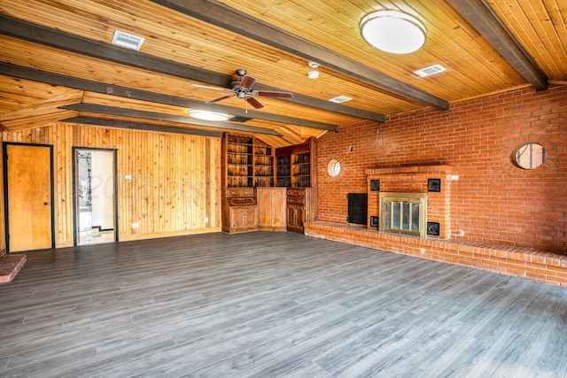 1802 Chama St, Amarillo, TX 79102 - unfurnished living room with wood finished floors, a brick fireplace, a ceiling fan, brick wall, and wood walls