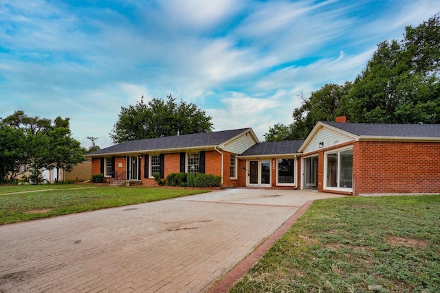 1802 Chama St, Amarillo, TX 79102 - ranch-style house with brick siding, decorative driveway, and a front yard
